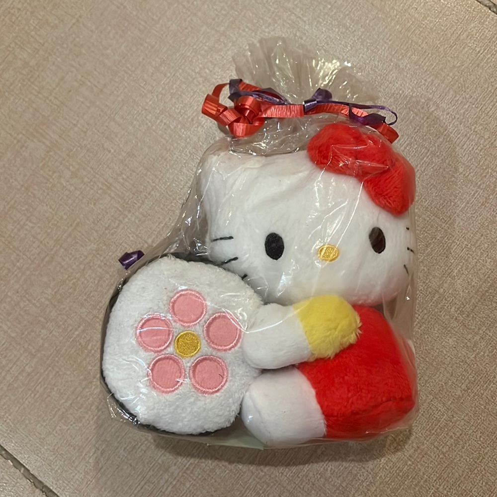 2 for/$20 Hello kitty hugging a sushi plush